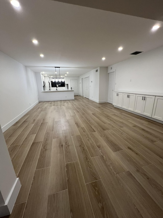 unfurnished living room featuring hardwood / wood-style flooring