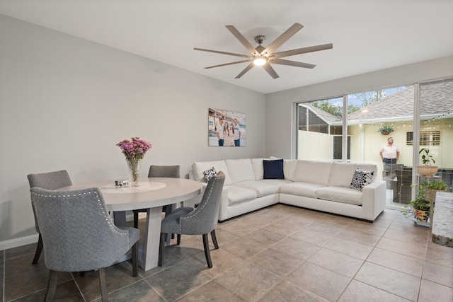 dining space with ceiling fan and tile patterned floors