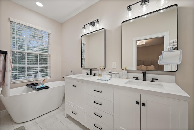 bathroom with tile patterned flooring, vanity, and a washtub