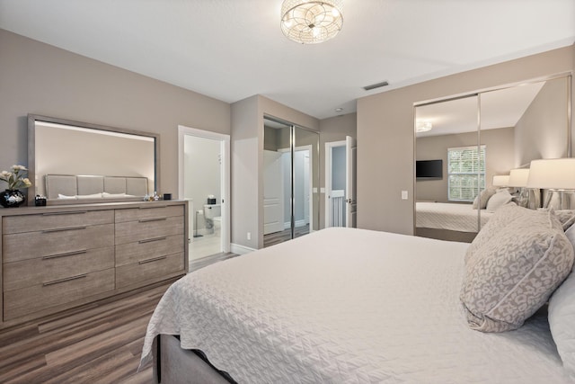 bedroom featuring connected bathroom and dark hardwood / wood-style floors