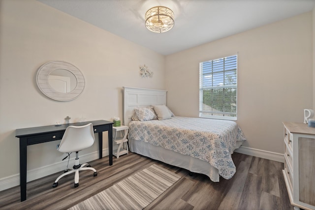 bedroom with dark hardwood / wood-style flooring