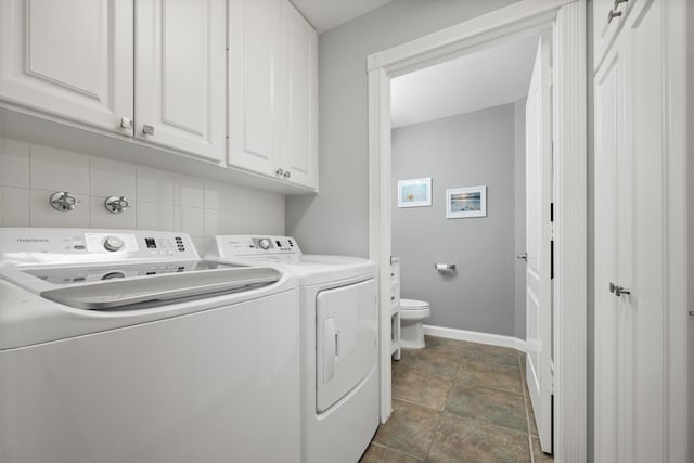 clothes washing area featuring cabinets and independent washer and dryer