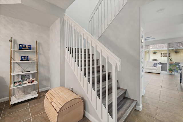 stairway with tile patterned flooring and ceiling fan