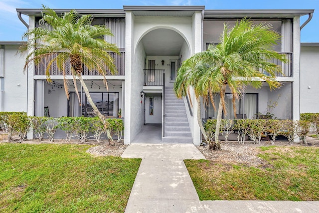 doorway to property featuring a yard