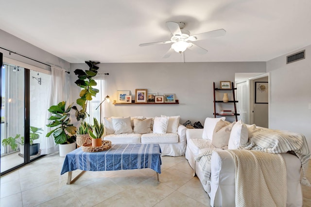 tiled living room with ceiling fan