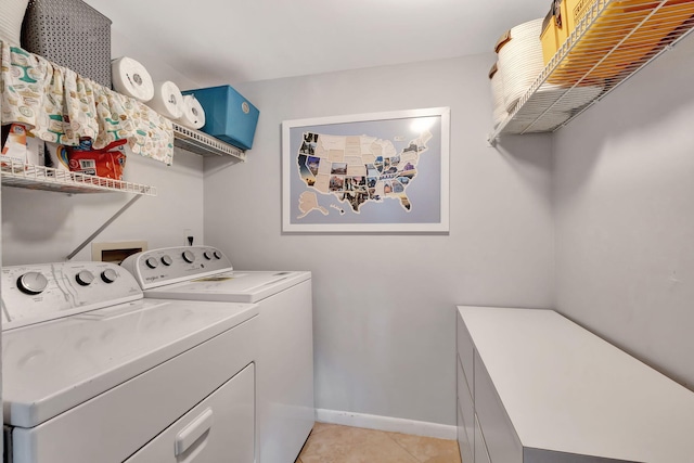 laundry room with light tile patterned floors and washing machine and clothes dryer