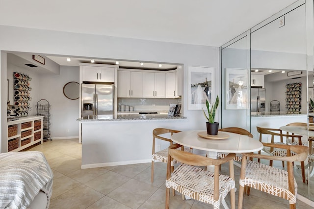 dining space featuring light tile patterned floors