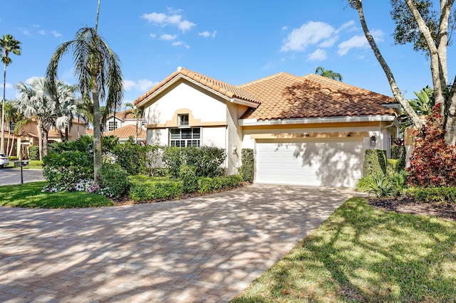 mediterranean / spanish home featuring a garage