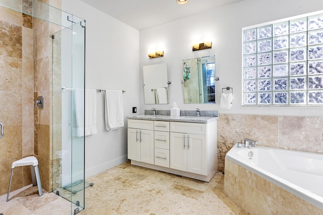 bathroom featuring vanity, a healthy amount of sunlight, and shower with separate bathtub