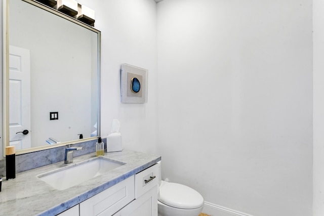 bathroom featuring toilet and vanity