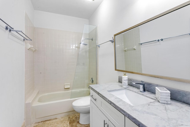 full bathroom featuring toilet, tiled shower / bath, and vanity