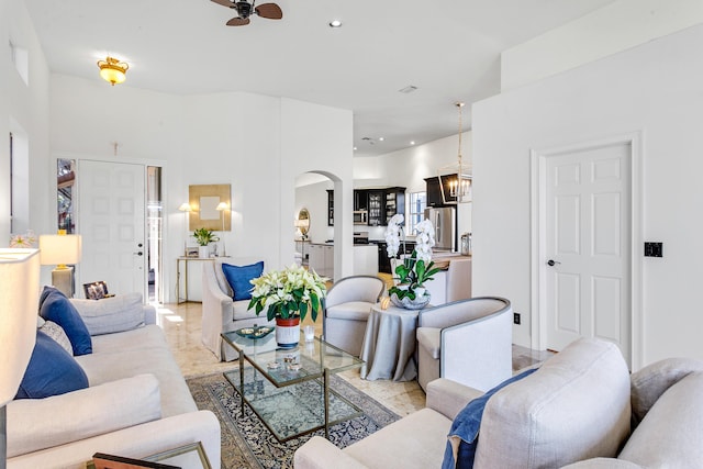 living room featuring ceiling fan with notable chandelier