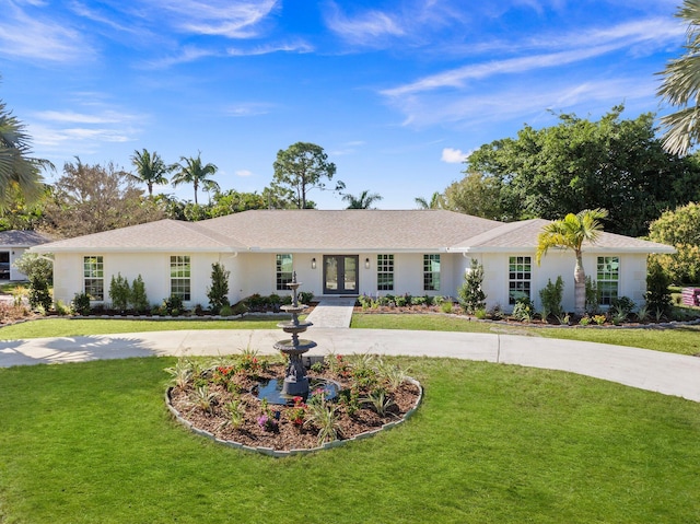 ranch-style home with a front yard and french doors