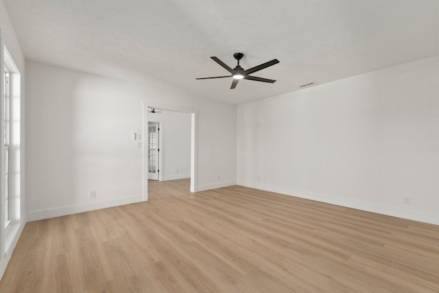 unfurnished room featuring ceiling fan, a textured ceiling, and light hardwood / wood-style flooring