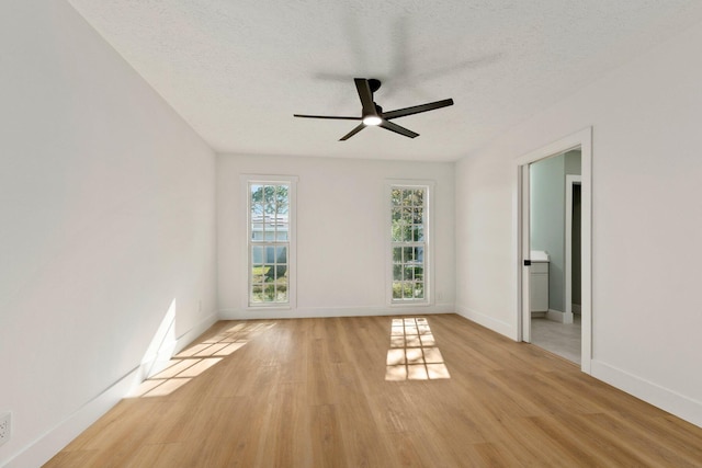 spare room featuring ceiling fan, plenty of natural light, and light hardwood / wood-style flooring