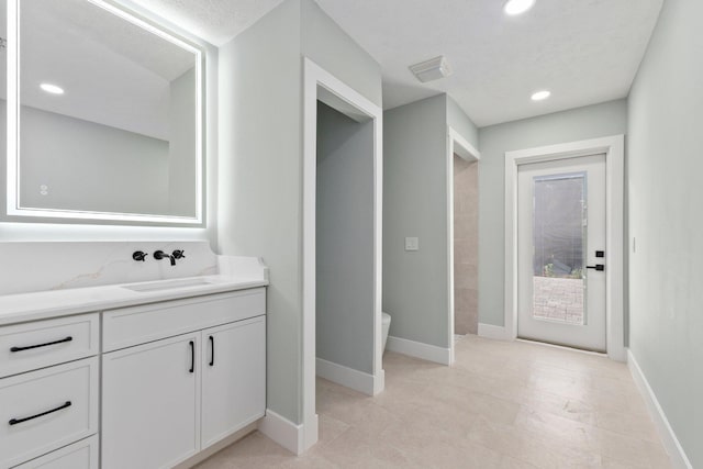 bathroom featuring toilet and vanity