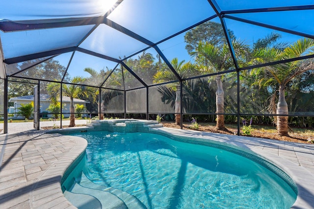 view of pool featuring glass enclosure and a patio area