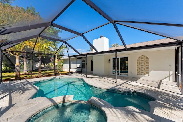 view of pool featuring a lanai, a patio, and an in ground hot tub