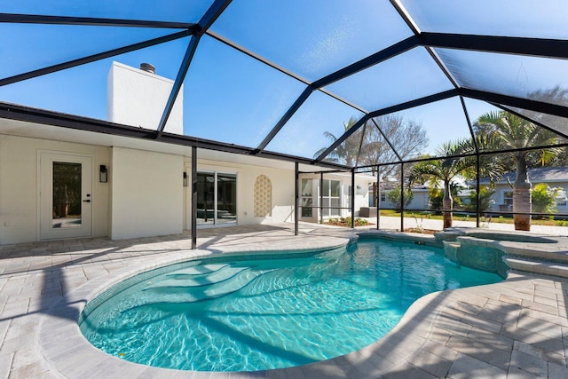 view of pool featuring a lanai, a patio, and an in ground hot tub