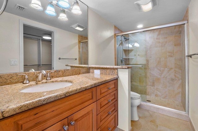 bathroom featuring toilet, vanity, an enclosed shower, and tile patterned flooring