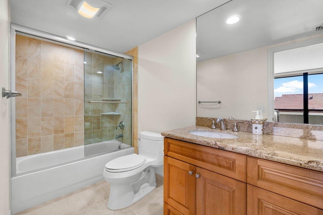 full bathroom featuring toilet, combined bath / shower with glass door, tile patterned floors, and vanity