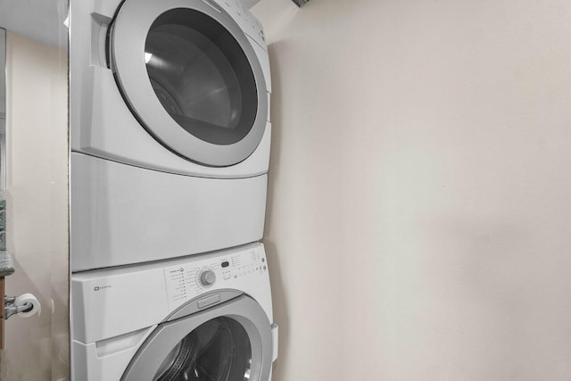 laundry room with stacked washer and dryer