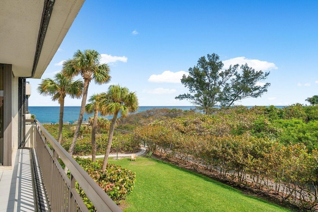 exterior space featuring a balcony and a water view