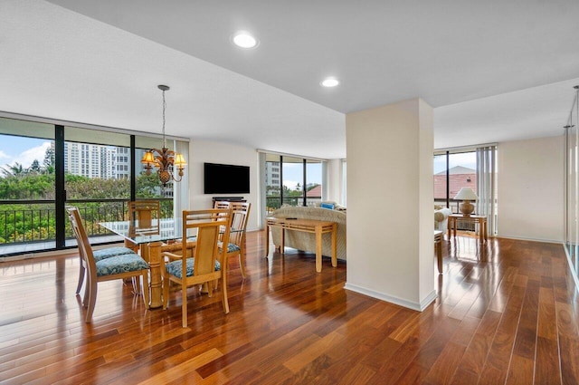 dining space with a wealth of natural light, expansive windows, and an inviting chandelier