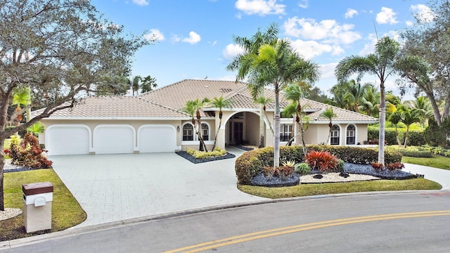 mediterranean / spanish-style house with a garage