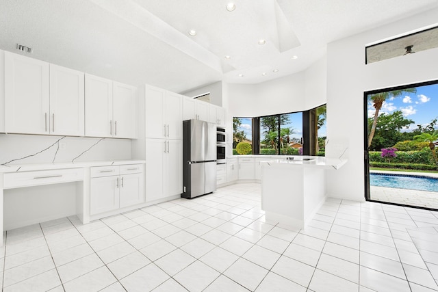 kitchen with white cabinetry and appliances with stainless steel finishes