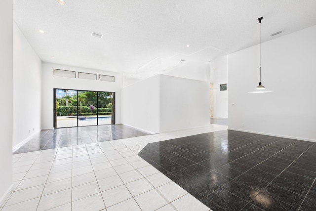 unfurnished room with a high ceiling