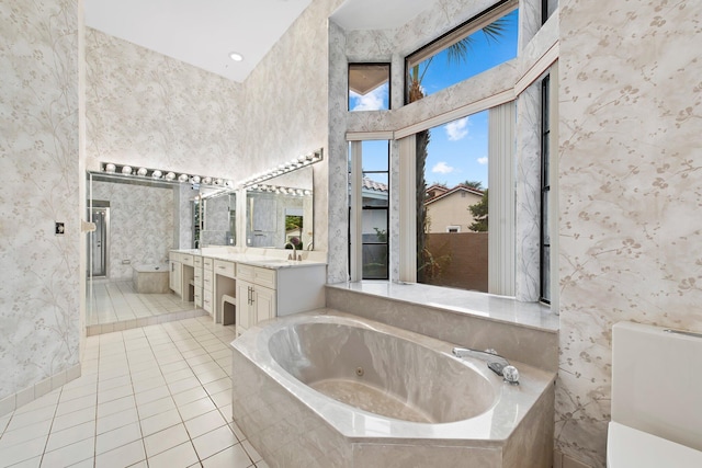 bathroom with vanity, tiled tub, and tile patterned floors