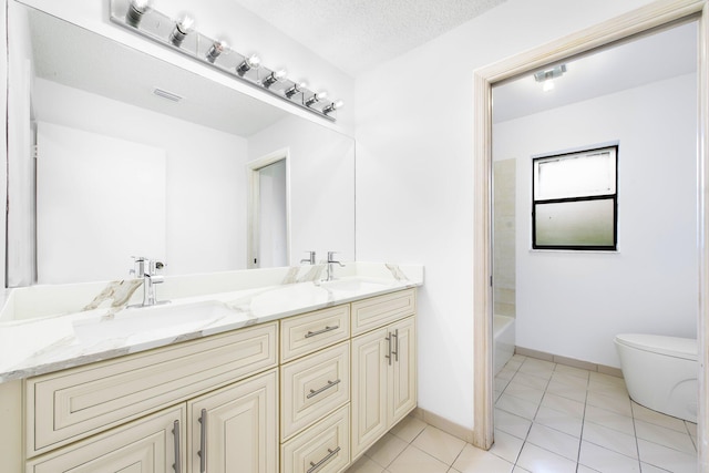 full bathroom featuring toilet, a textured ceiling, vanity, shower / bath combination, and tile patterned flooring