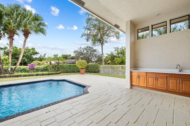 view of pool with sink and a patio area