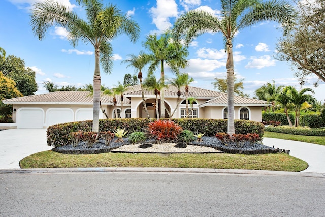 mediterranean / spanish home featuring a garage