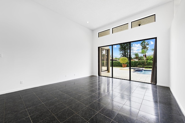 unfurnished room featuring a high ceiling