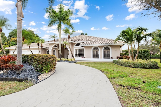 mediterranean / spanish-style home featuring a front yard