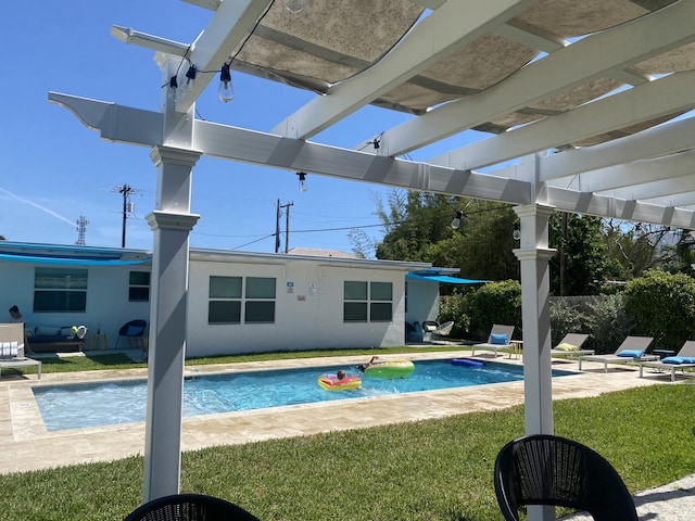 view of swimming pool featuring a lawn and a pergola