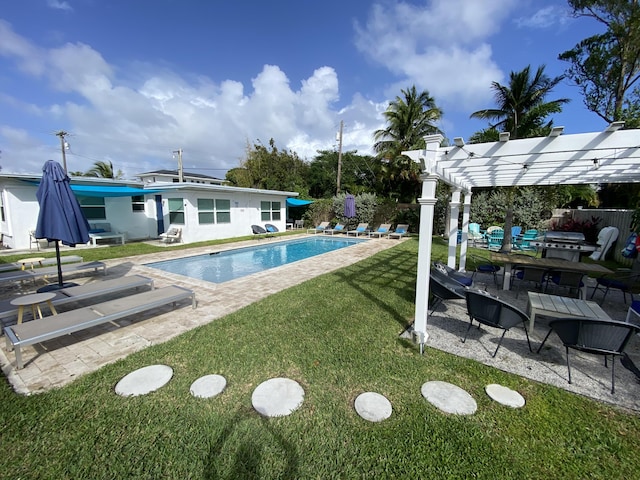 view of swimming pool with a lawn, a pergola, and a patio area