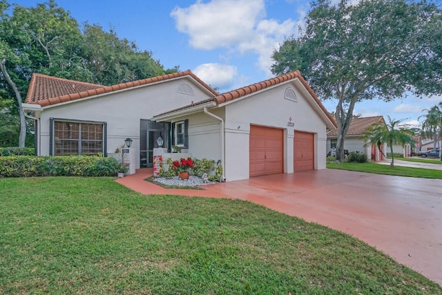 mediterranean / spanish-style house with a front lawn and a garage