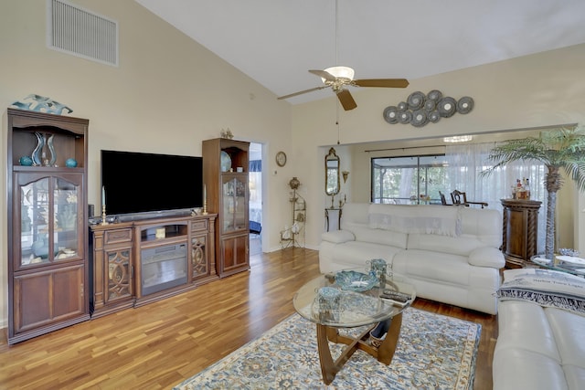 living room with ceiling fan, high vaulted ceiling, and hardwood / wood-style floors