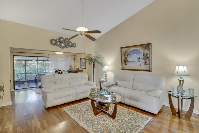 living room with ceiling fan, high vaulted ceiling, and hardwood / wood-style flooring