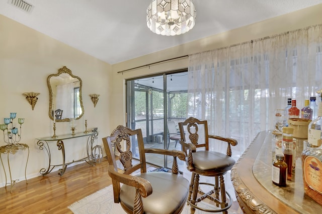 sitting room featuring an inviting chandelier and wood-type flooring