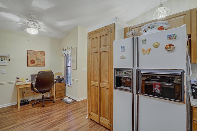 kitchen with ceiling fan, light wood-type flooring, lofted ceiling, white fridge with ice dispenser, and a textured ceiling