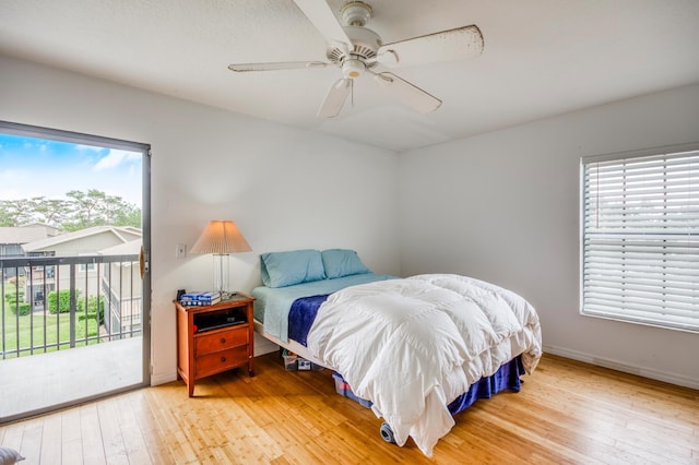 bedroom featuring hardwood / wood-style flooring, access to outside, and ceiling fan