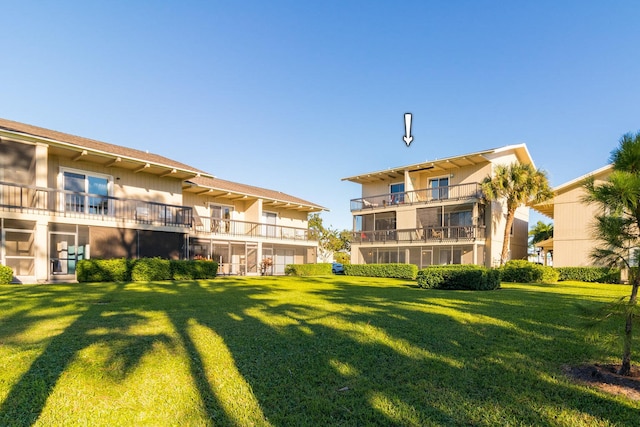 view of home's community featuring a lawn