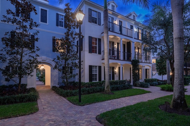 view of front of house featuring a balcony