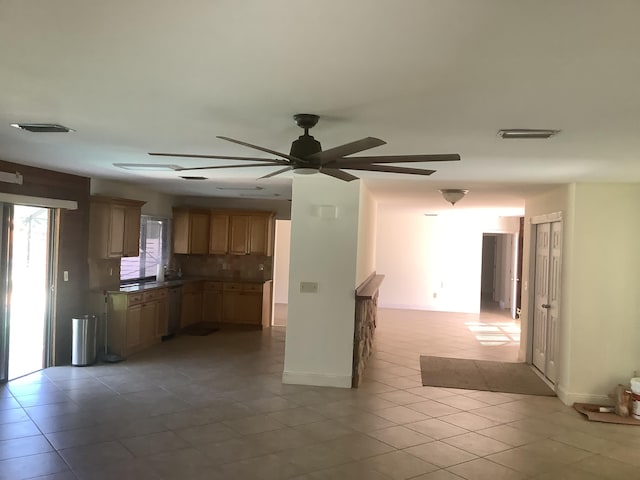 kitchen featuring ceiling fan, decorative backsplash, dishwasher, and light tile patterned flooring