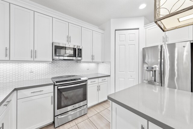 kitchen with dishwasher, pendant lighting, sink, white cabinetry, and built in shelves