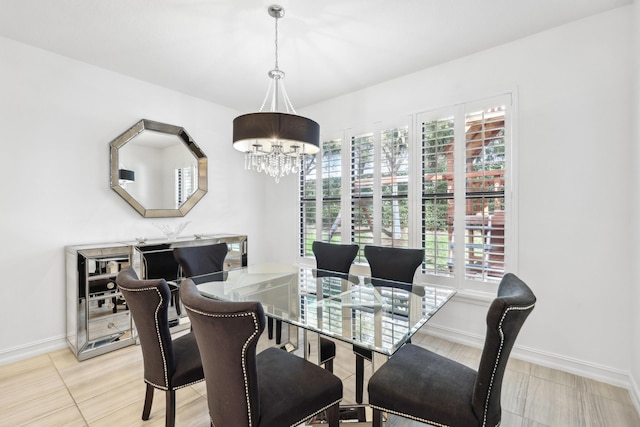 dining area featuring light tile patterned flooring and an inviting chandelier